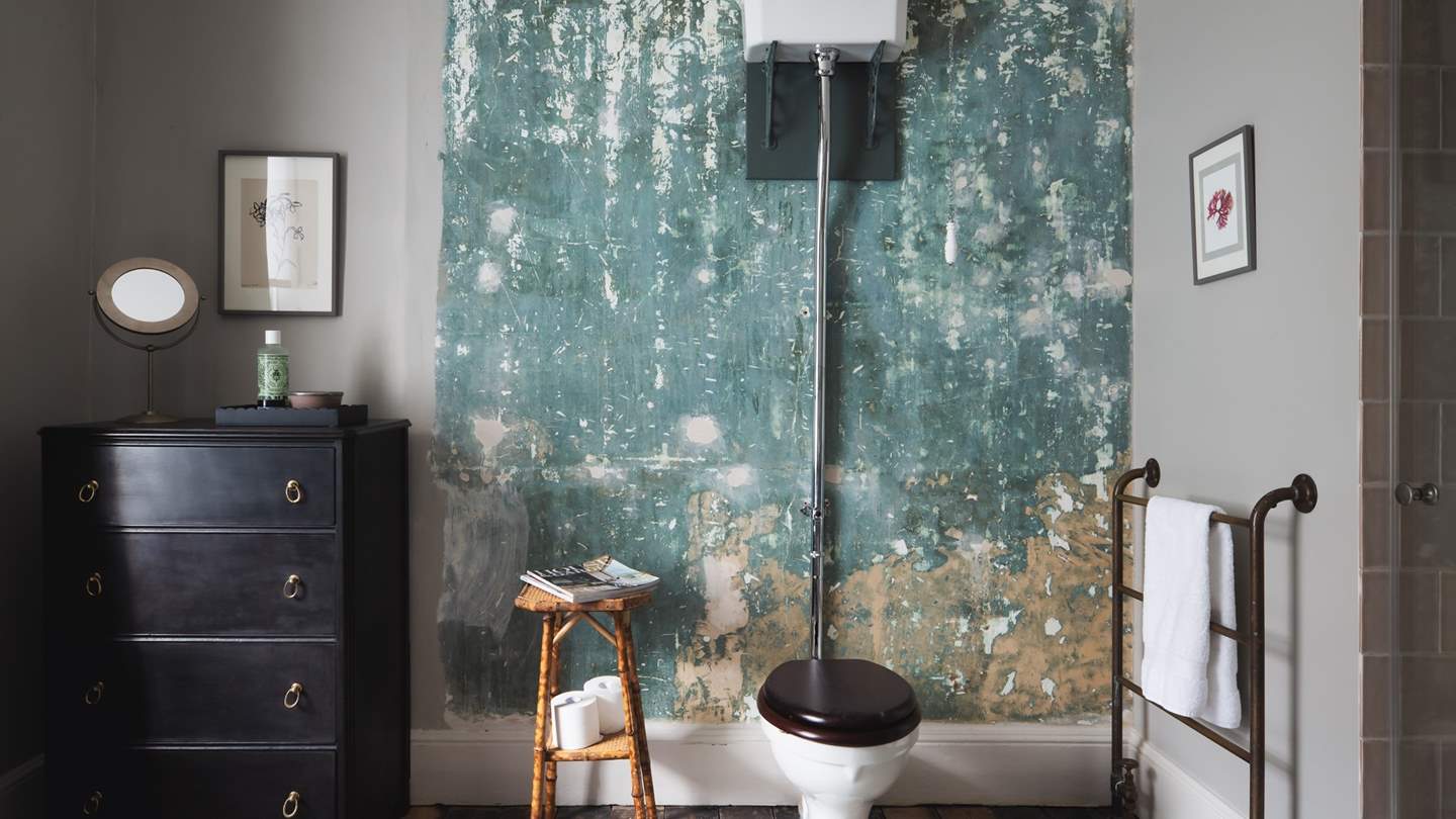 The clever interior designer owner has left touches of history throughout - such as this exposed wall, showcasing original paintwork