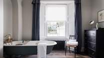 The impressive en suite to the master bedroom - perfect for long soaks - with views over the garden