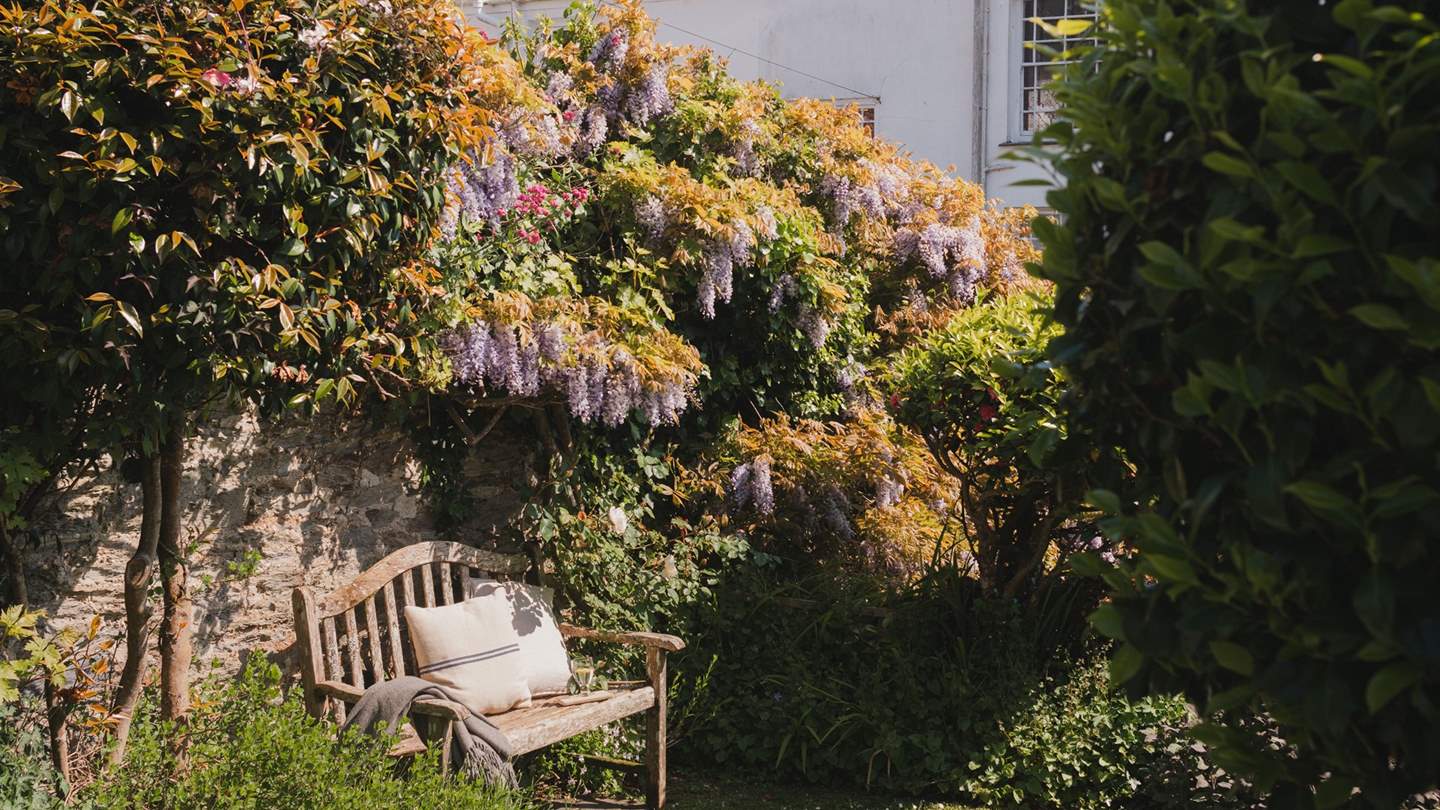 This sweet bench is made for whiling away an hour or two, with a glass of wine and a good book