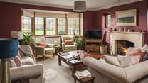 The homely sitting room, perfect for family gatherings around the open fire 