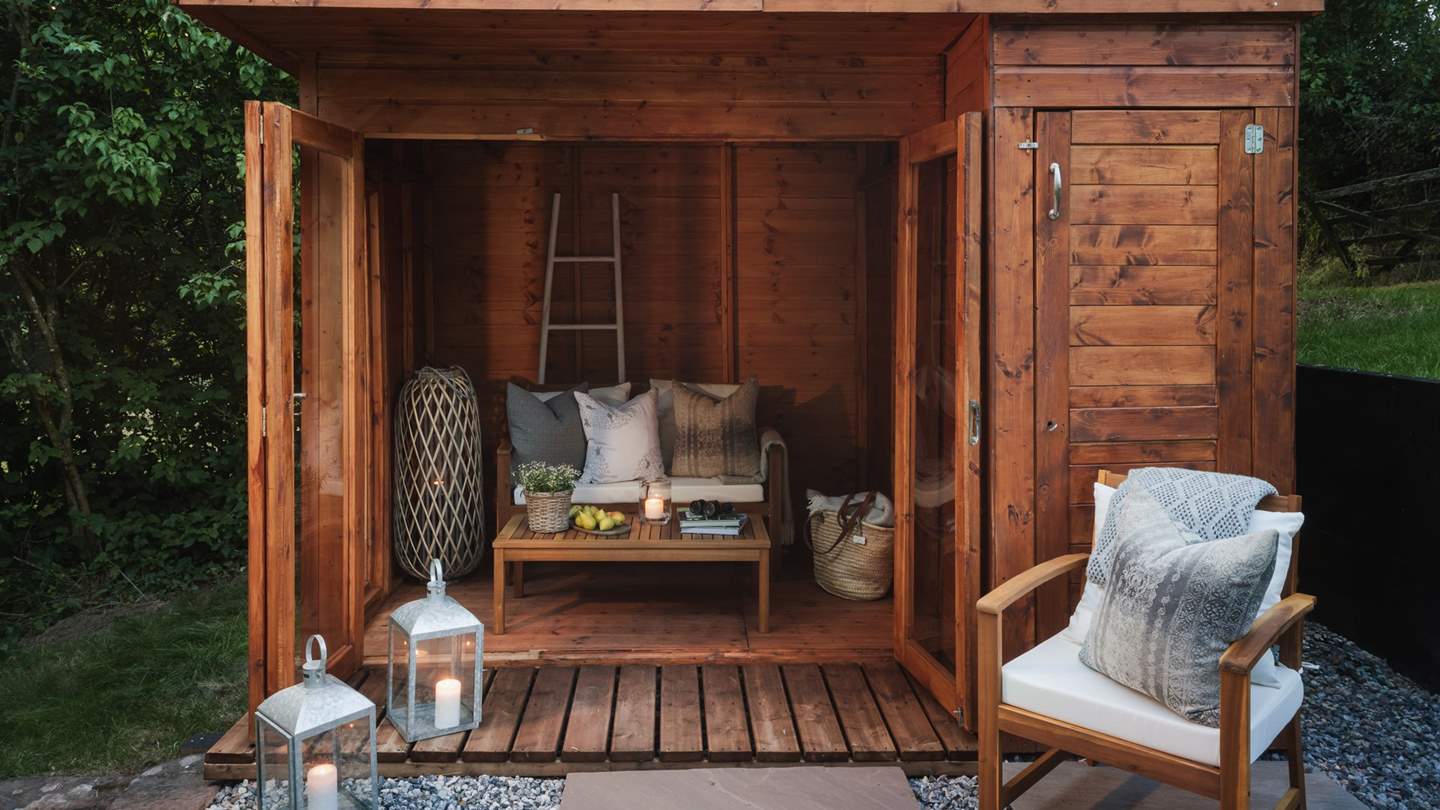 For those seeking a serene spot, there's a sweet summerhouse complete with a luxe outdoor sofa and two armchairs