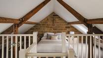 Settled in the eaves, the mezzanine bedroom space is simply a dream...