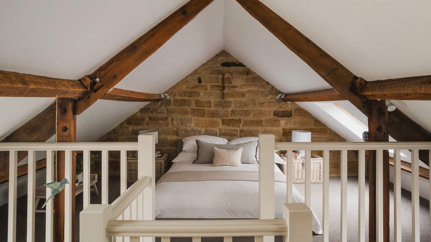 Settled in the eaves, the mezzanine bedroom space is simply a dream...
