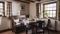 We just love the pretty dining room complete with antique bench and beamed ceiling