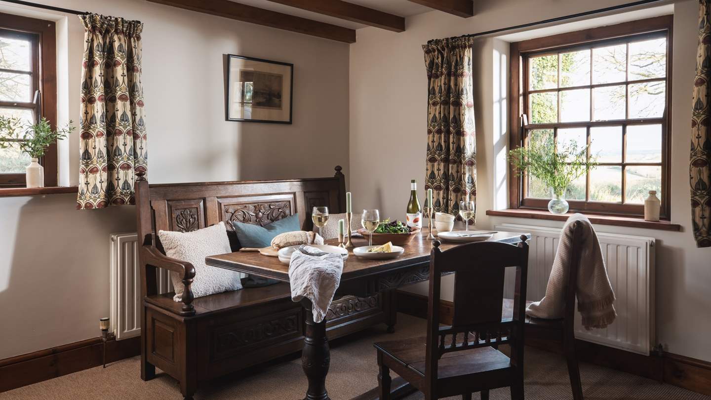 We just love the pretty dining room complete with antique bench and beamed ceiling