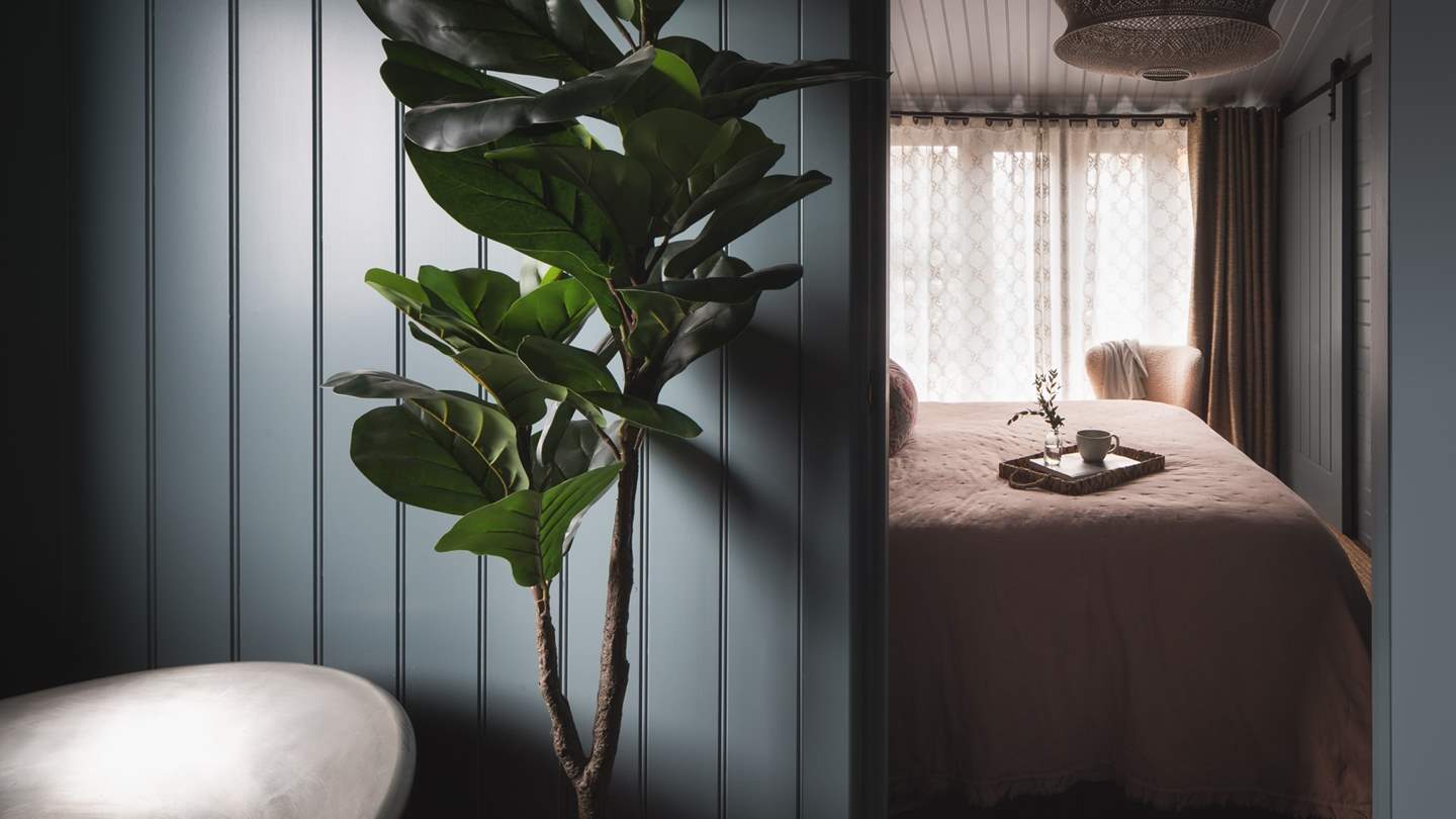 Tucked away, the bedroom is a quiet space to retire to