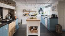 The kitchen island offers plenty of space for preparing meals with the family 