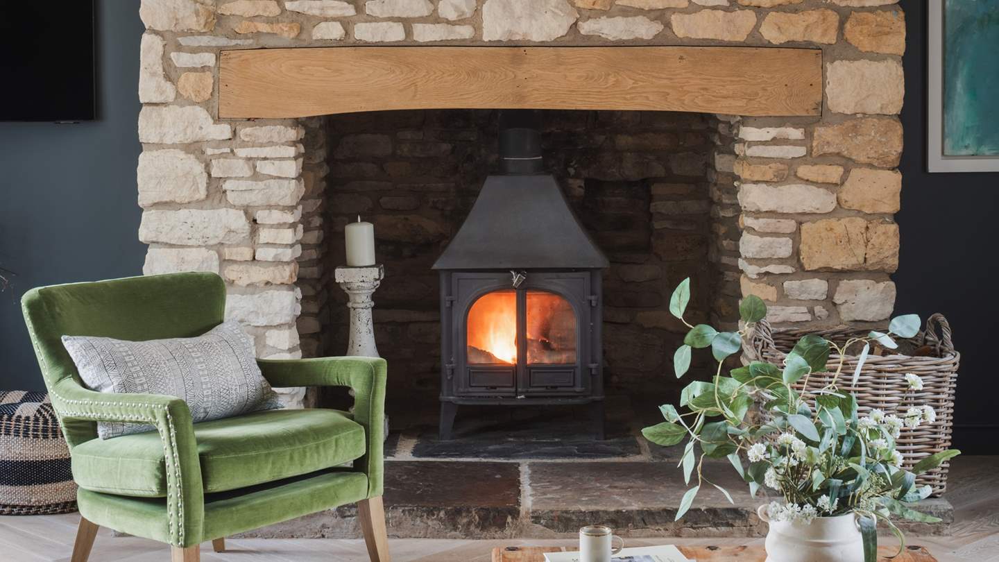The gorgeous living room invites snug moments, with a handsome wood burning stove taking centre stage, perfectly set within an idyllic, inglenook fireplace