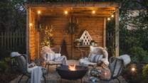 Festoon lights adorn both the hot tub and fire pit areas, this magical outdoor space truly offers a little piece of paradise in the country