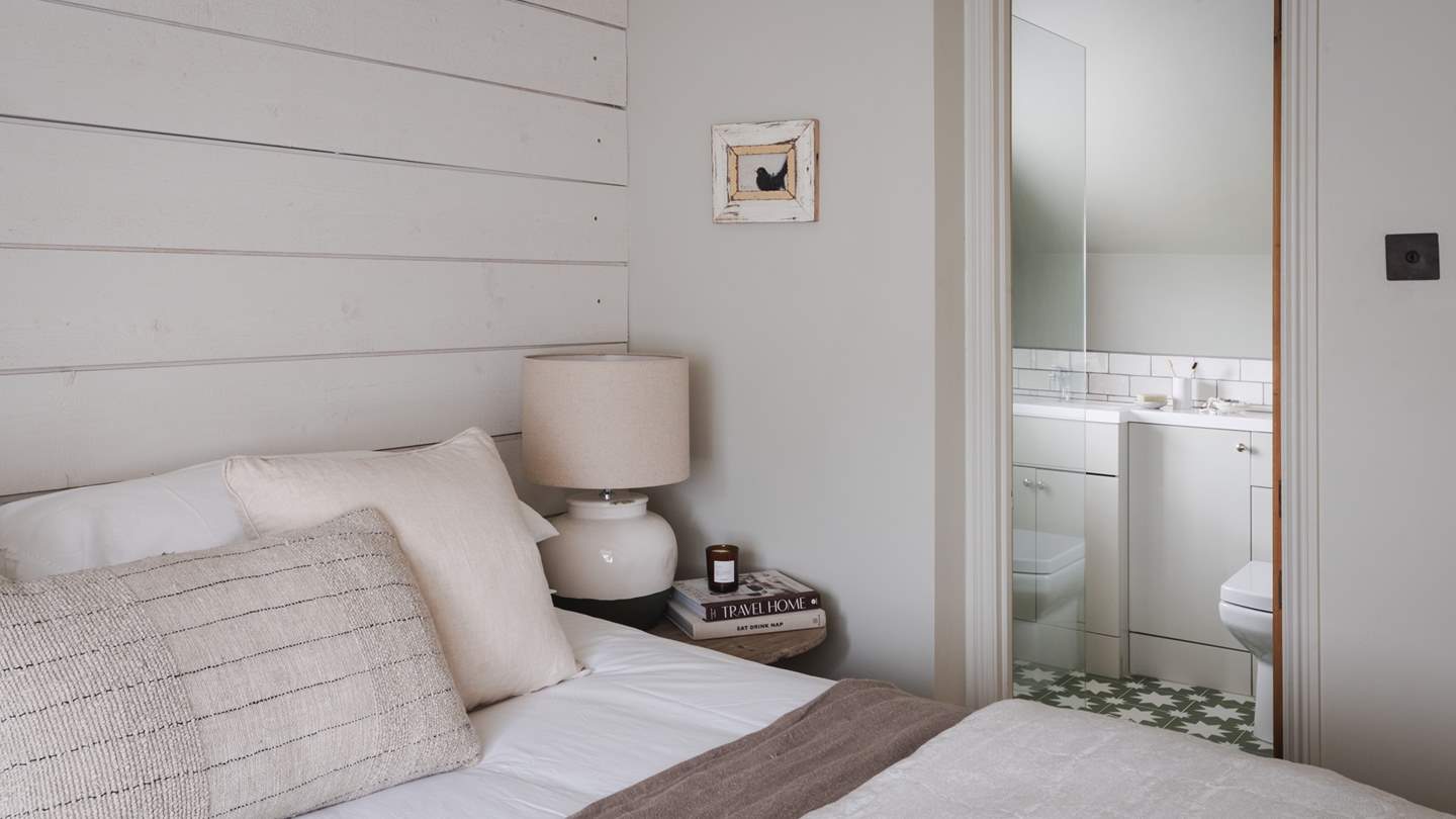 The en suite wet room is decorated in harmony with its adjoining bedroom, a gorgeous spot to refresh and reset after a day of Cotswold adventures