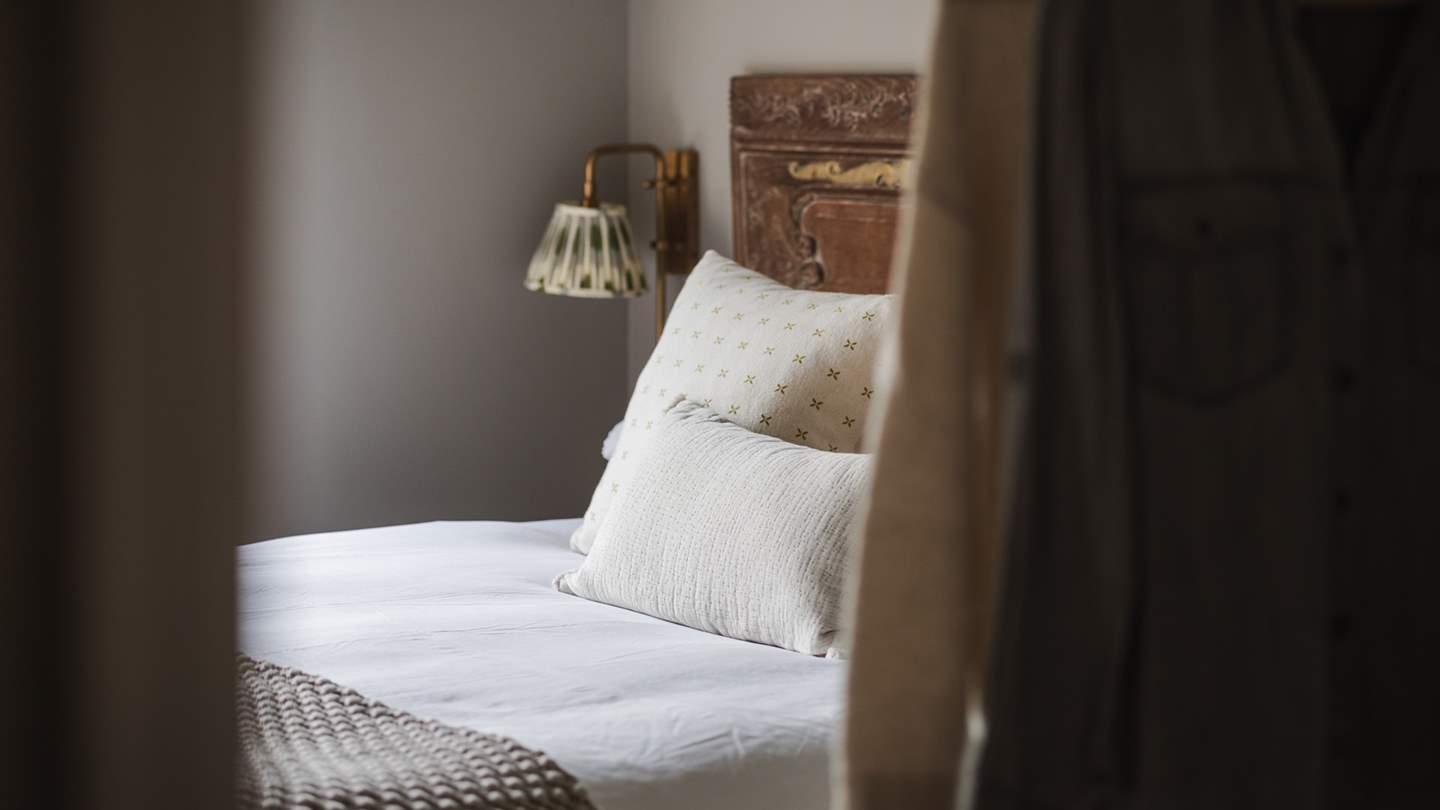 Bedroom four features a double bed in blissful hues with beautiful, antique headboard and vintage touches