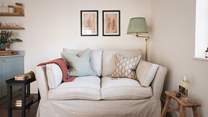 Cosy up on this snug sofa with a glass of something special in hand 
