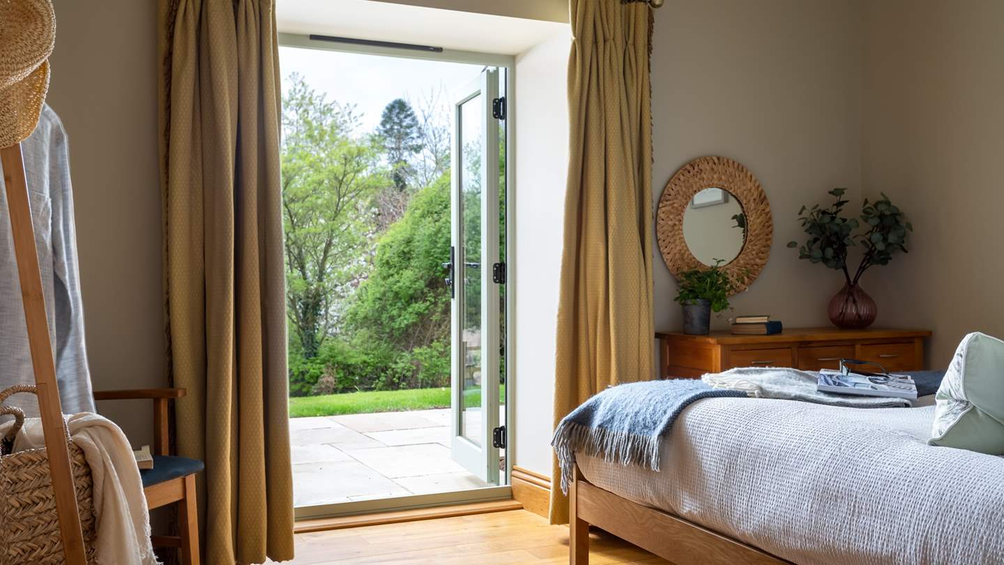 Double doors lead out from this room into the garden - enjoy a pretty view from the comfort of bed!