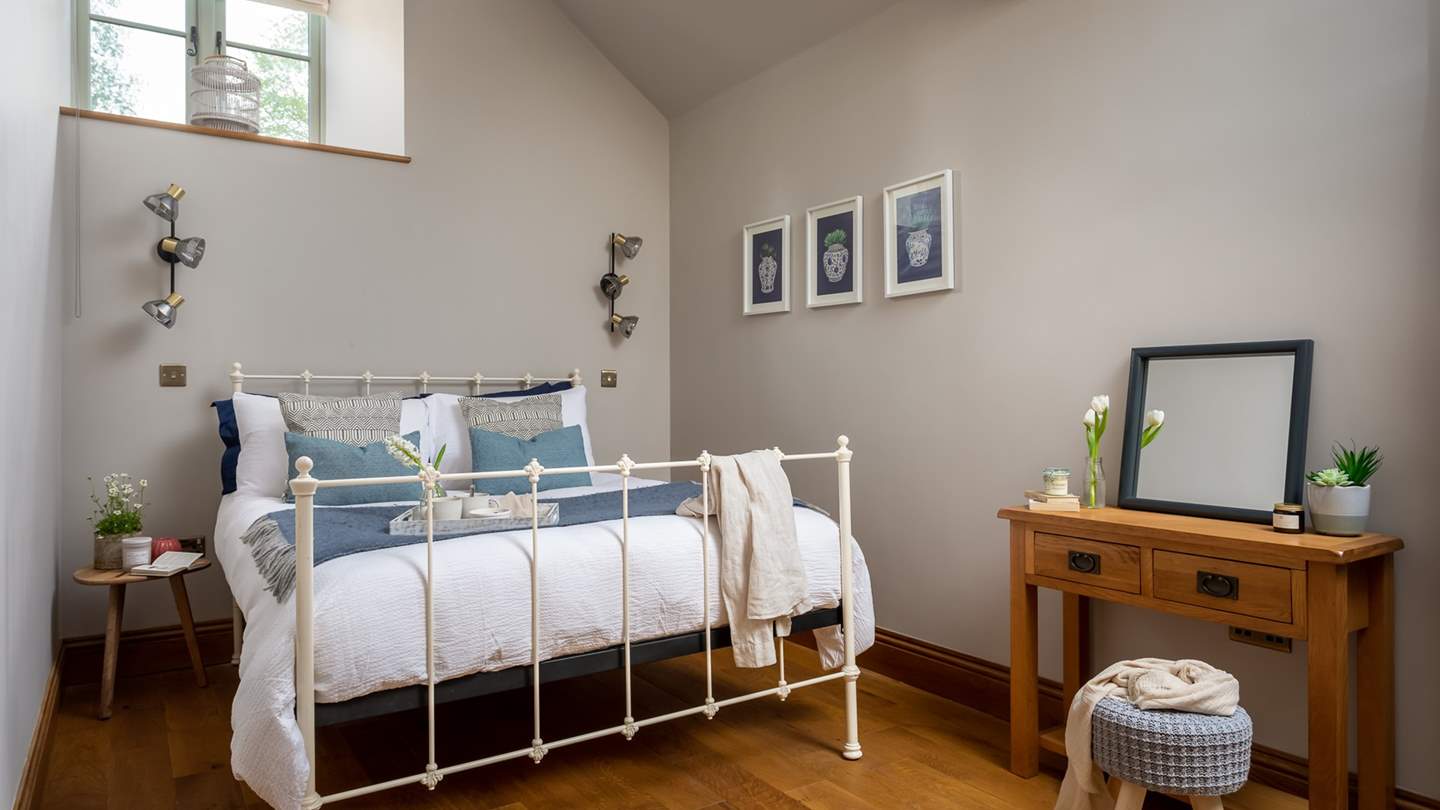 The master en suite bedroom,  with king sized wrought iron bed