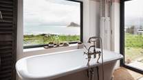 The stunning bathtub for two boasts hypnotic views, whatever time of day you bathe