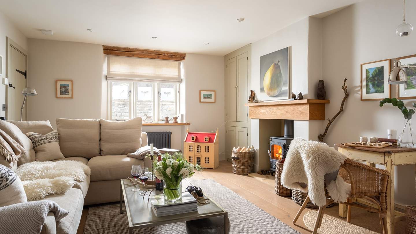 The cosy sitting room, complete with L-shaped sofa and flickering wood burner