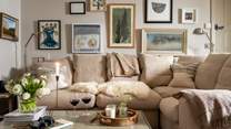 The welcoming sofa - just made for sprawling on - and fabulously eclectic artwork