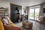 With flickering wood burner and countryside views, the sitting area is the perfect place to retire to at the end of a busy day exploring