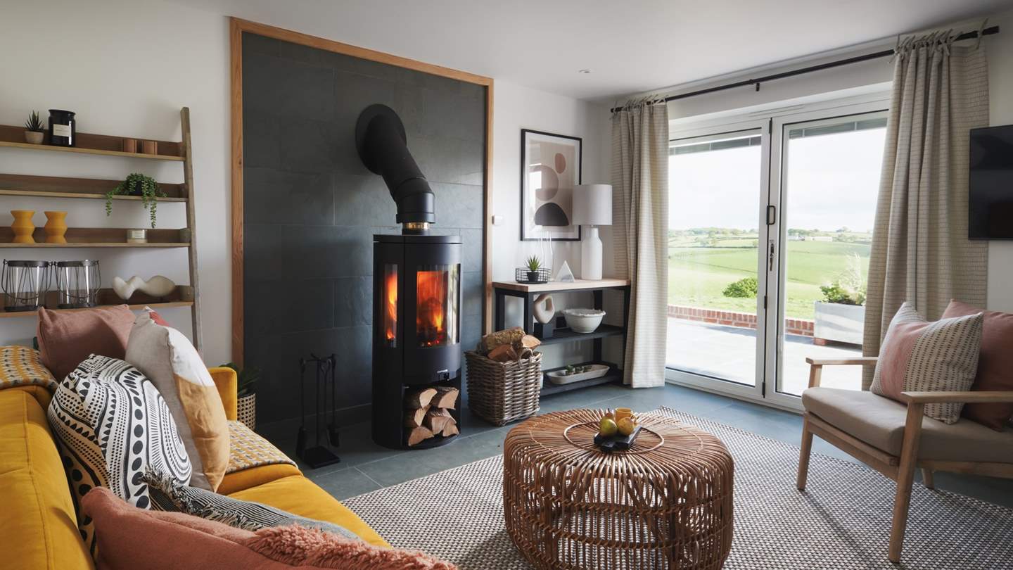 With flickering wood burner and countryside views, the sitting area is the perfect place to retire to at the end of a busy day exploring