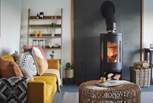 The majestic wood burner reigns supreme, offering flickering, cosy warmth just perfect to curl up in front of