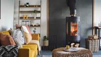 The majestic wood burner reigns supreme, offering flickering, cosy warmth just perfect to curl up in front of