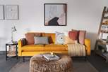 The mustard yellow sofa resplendent in cushions is made for sprawling on...