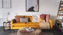 The mustard yellow sofa resplendent in cushions is made for sprawling on...