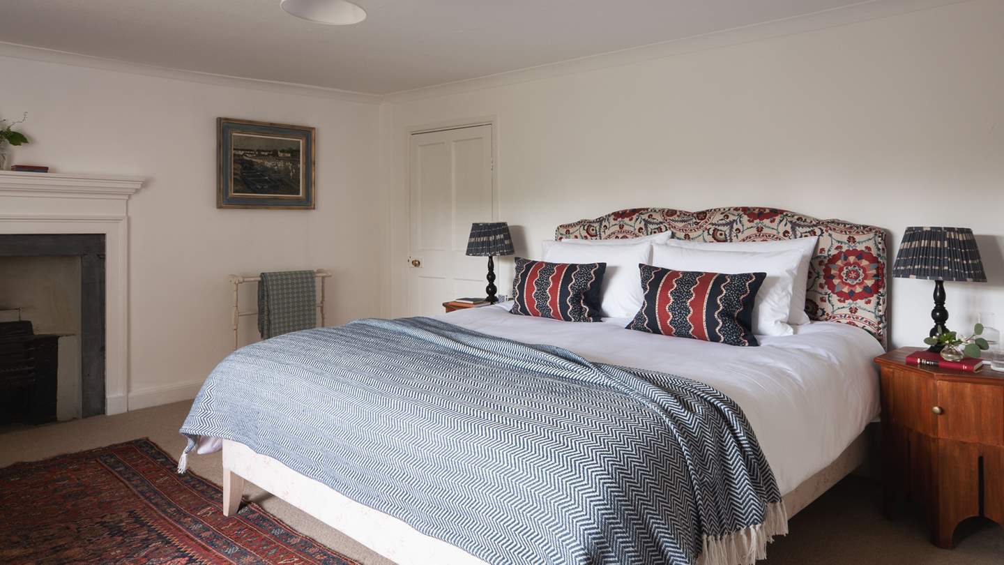 The en suite master bedroom in jewel-rich blues and red
