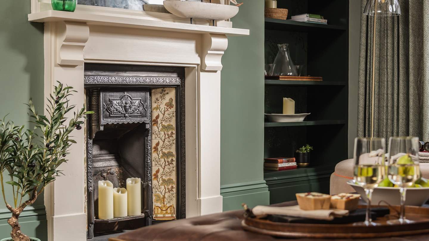 The exquisite original fireplace is a stunning feature of this beautiful room