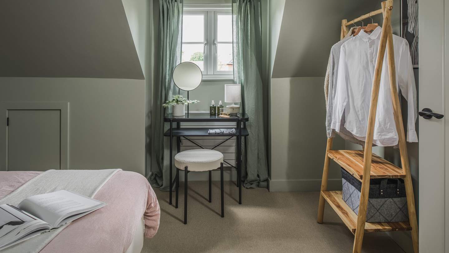 The elegant dressing table and charming clothes rail