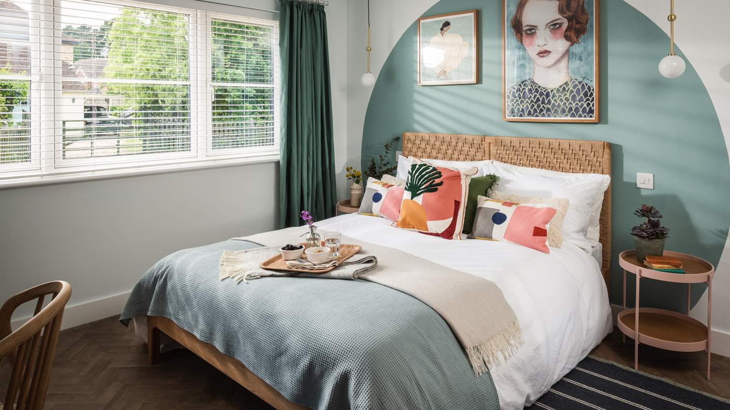 The master bedroom lies on the ground floor, boasting a king-size bed and eye-catching artwork 