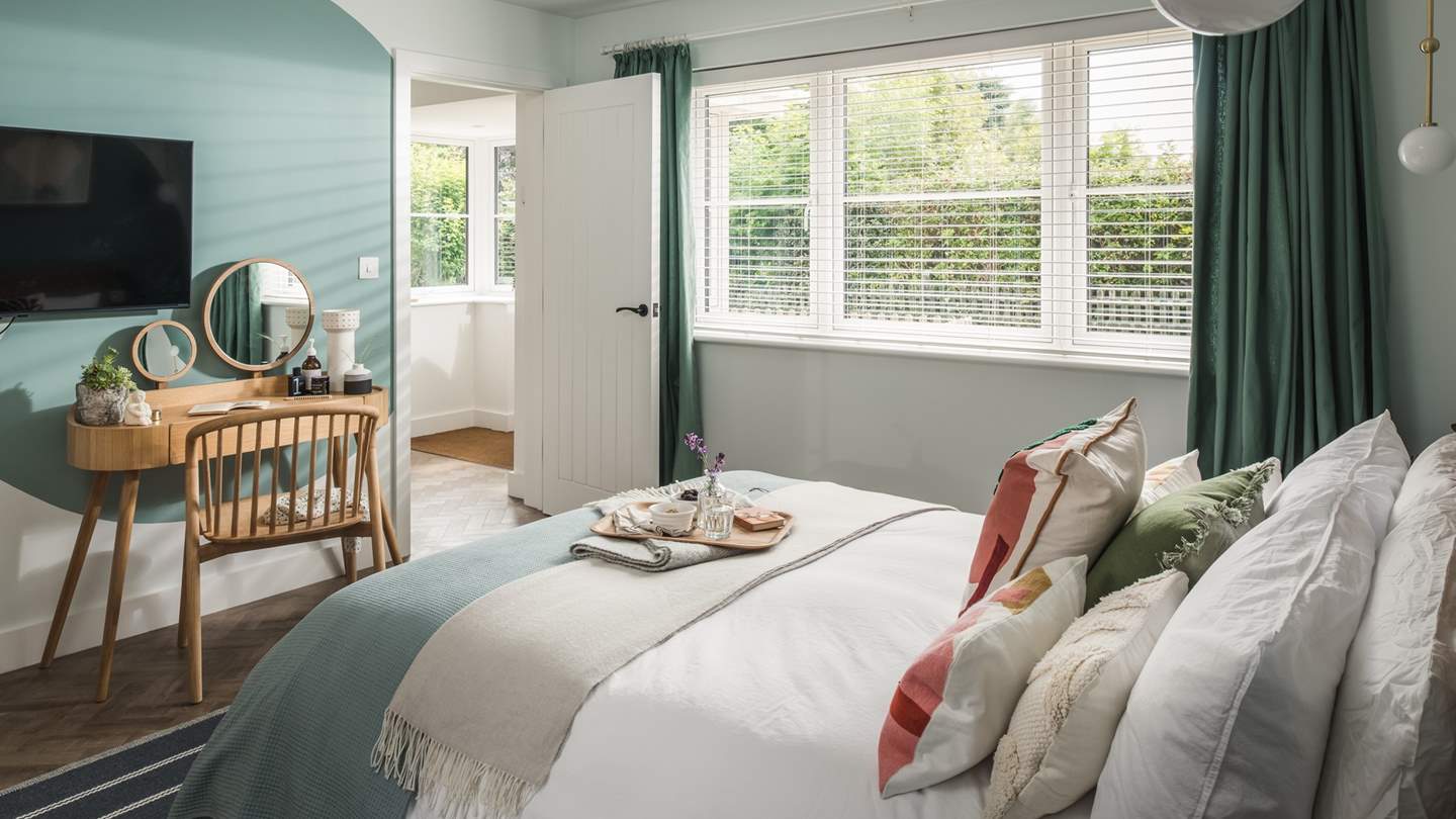 The cosy master bedroom is dreamy in teal hues 