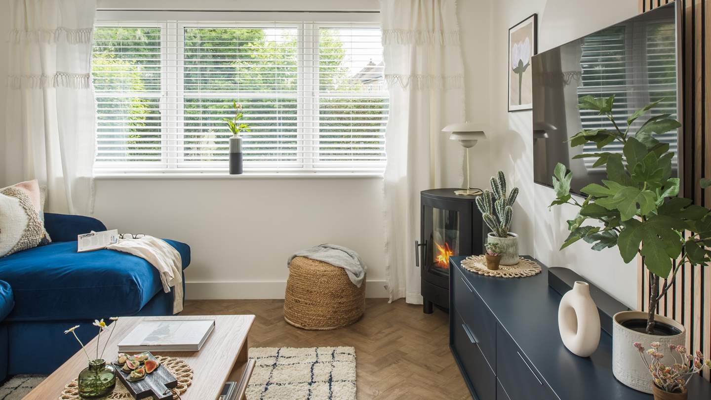 The snug living area is complete with a flickering wood burner for those chilly days 