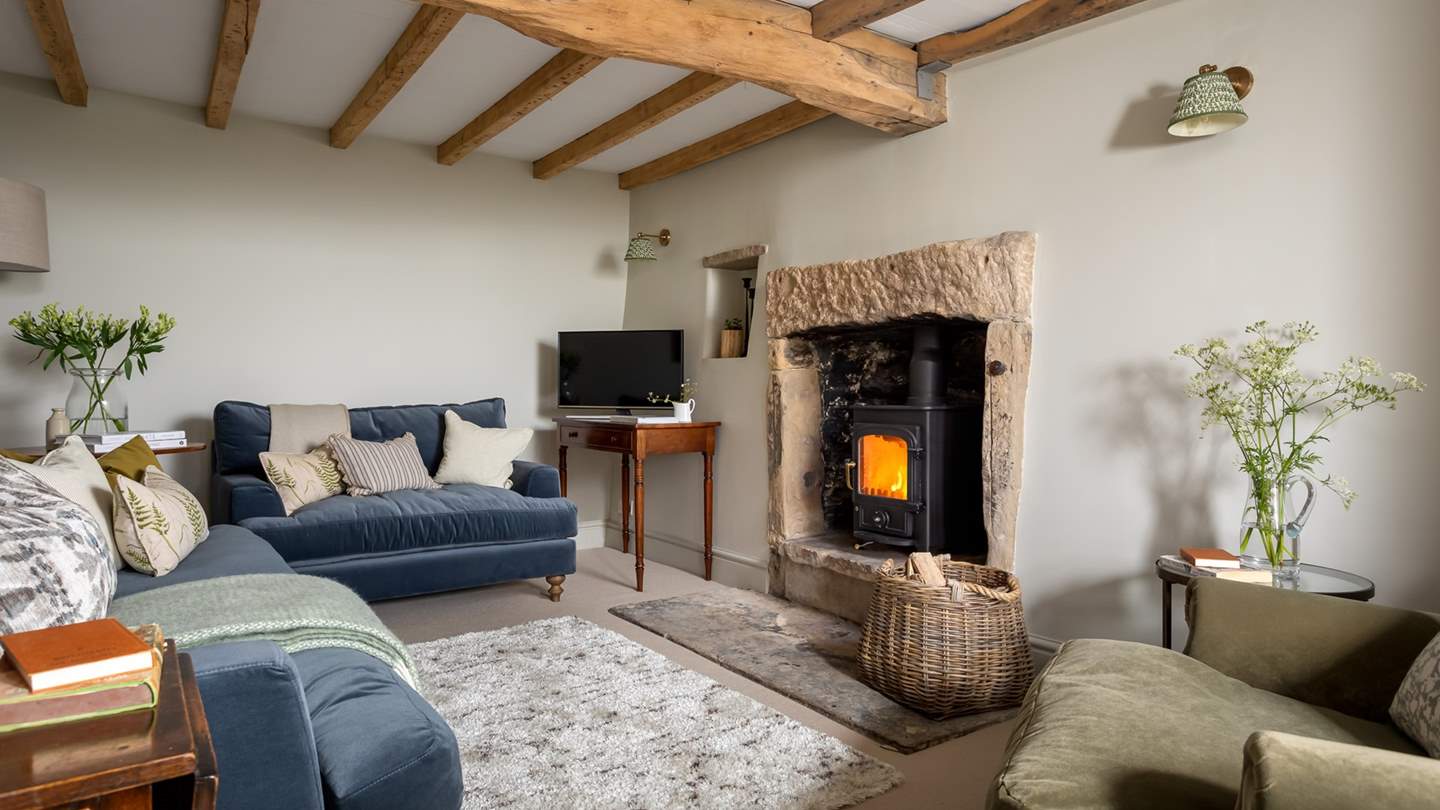 The pretty sitting room with exposed beams and wood burner is an idyllic retreat at the end of a busy day exploring