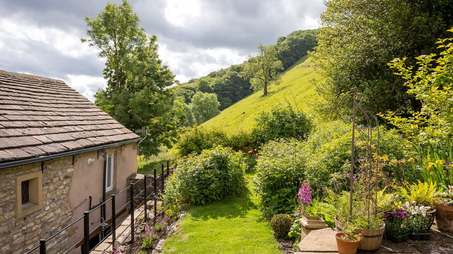 Out back, reflecting the steep hill that surrounds the cottage, is a gorgeous tiered garden