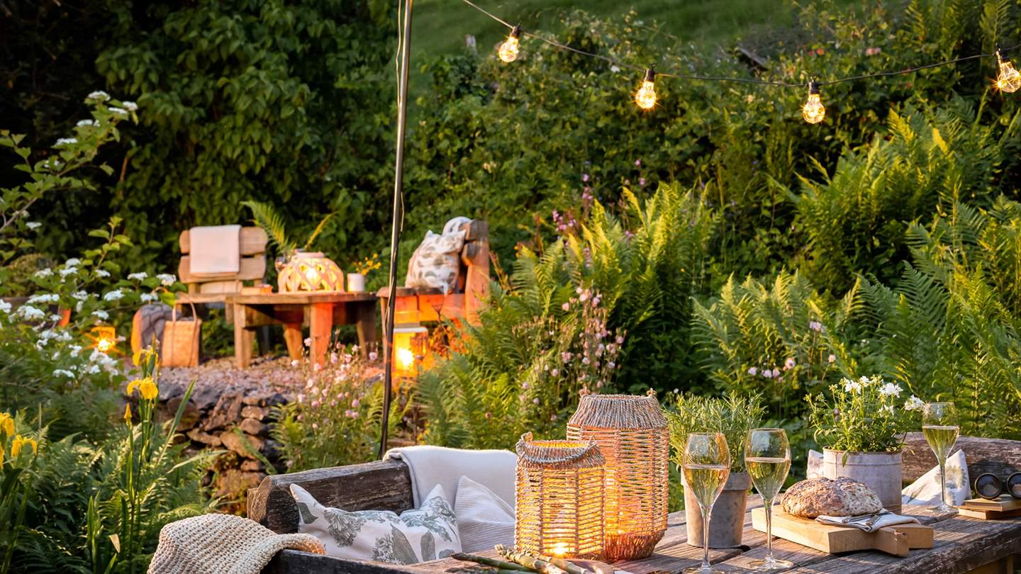 The stunning tiered garden, backed by rolling countryside, is a magical space that's perfect for relaxing and alfresco dining, whatever time of day it is