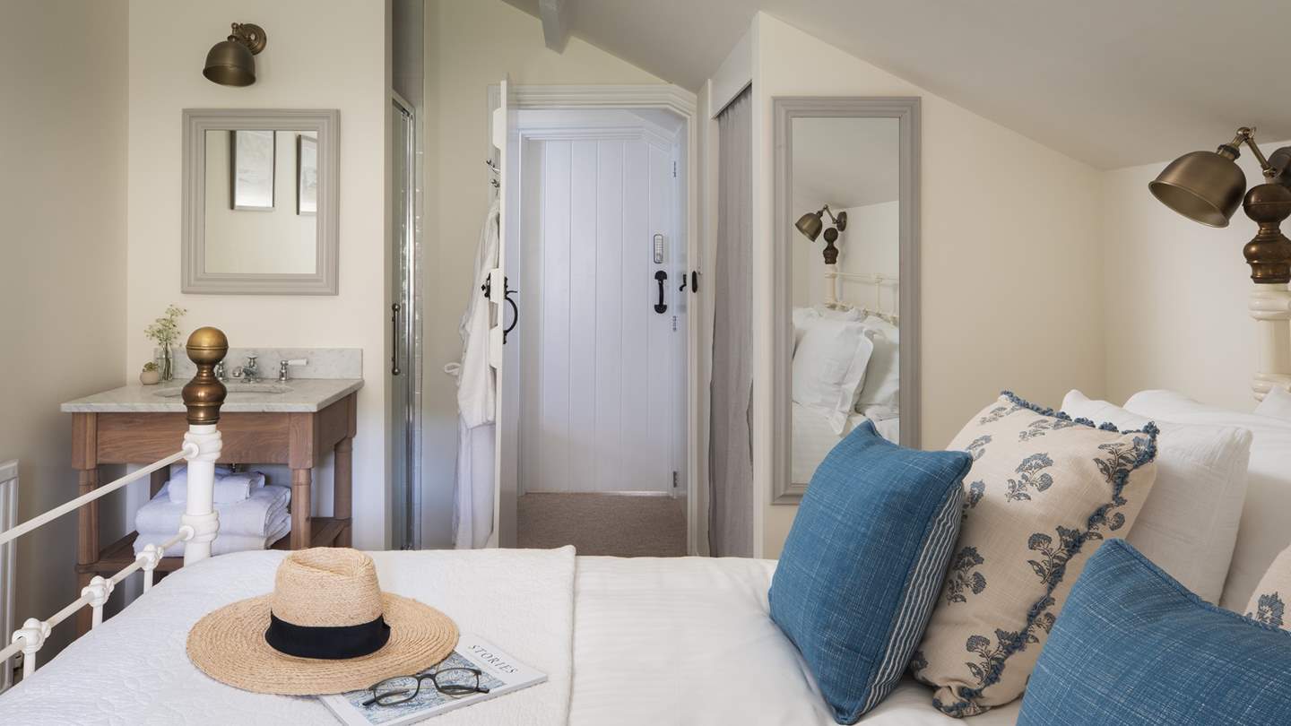 This room benefits from a pretty marble sink in the bedroom, as well as a shower