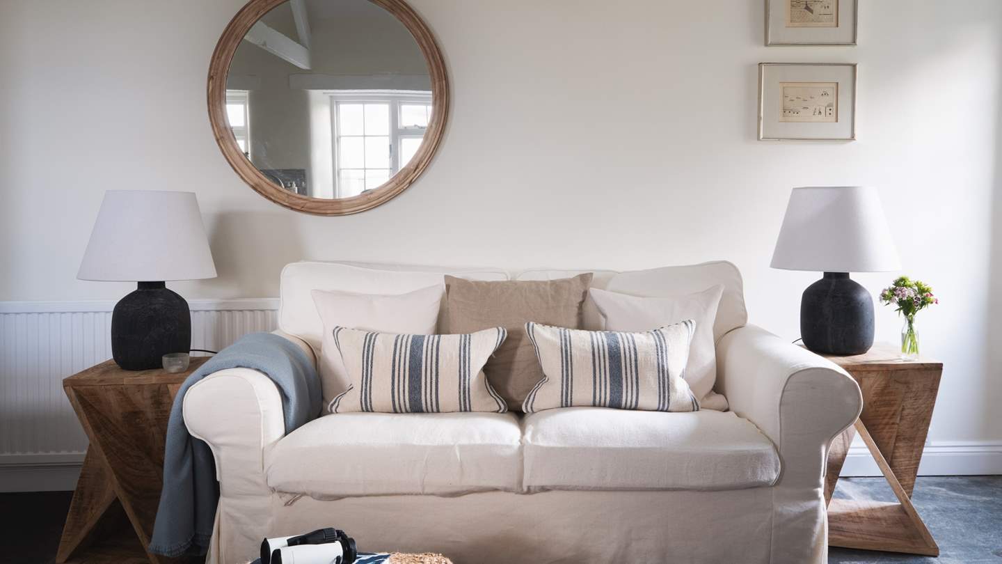 The cosy sofa is the perfect spot for cuddling up, gazing out over the spectacular view