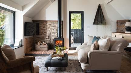 The sumptuous sitting area with oh-so-cosy sofa and wood burner is the ultimate in relaxation