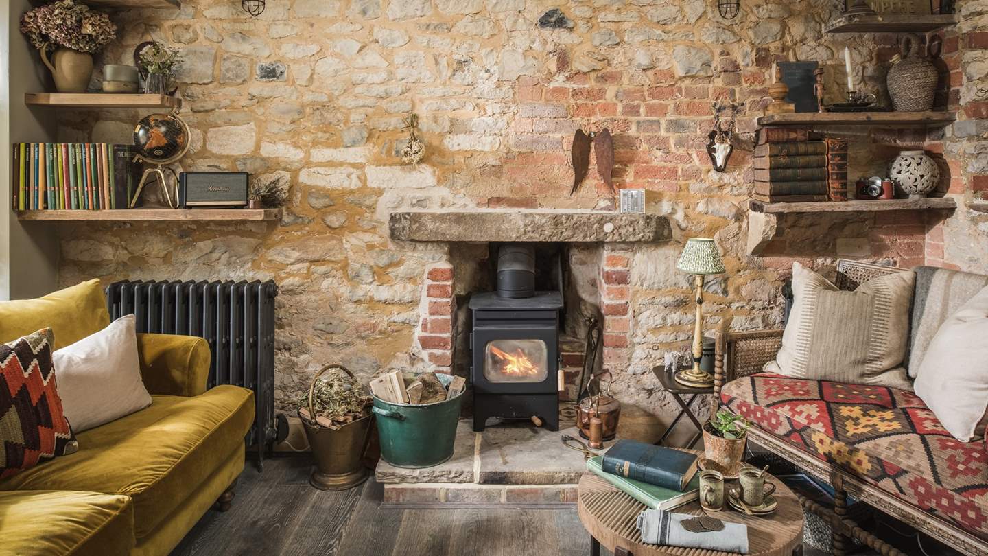 The wonderful sitting area, complete with a wood burner, comfortable sofa and snug loveseat is perfect for cosy evenings in