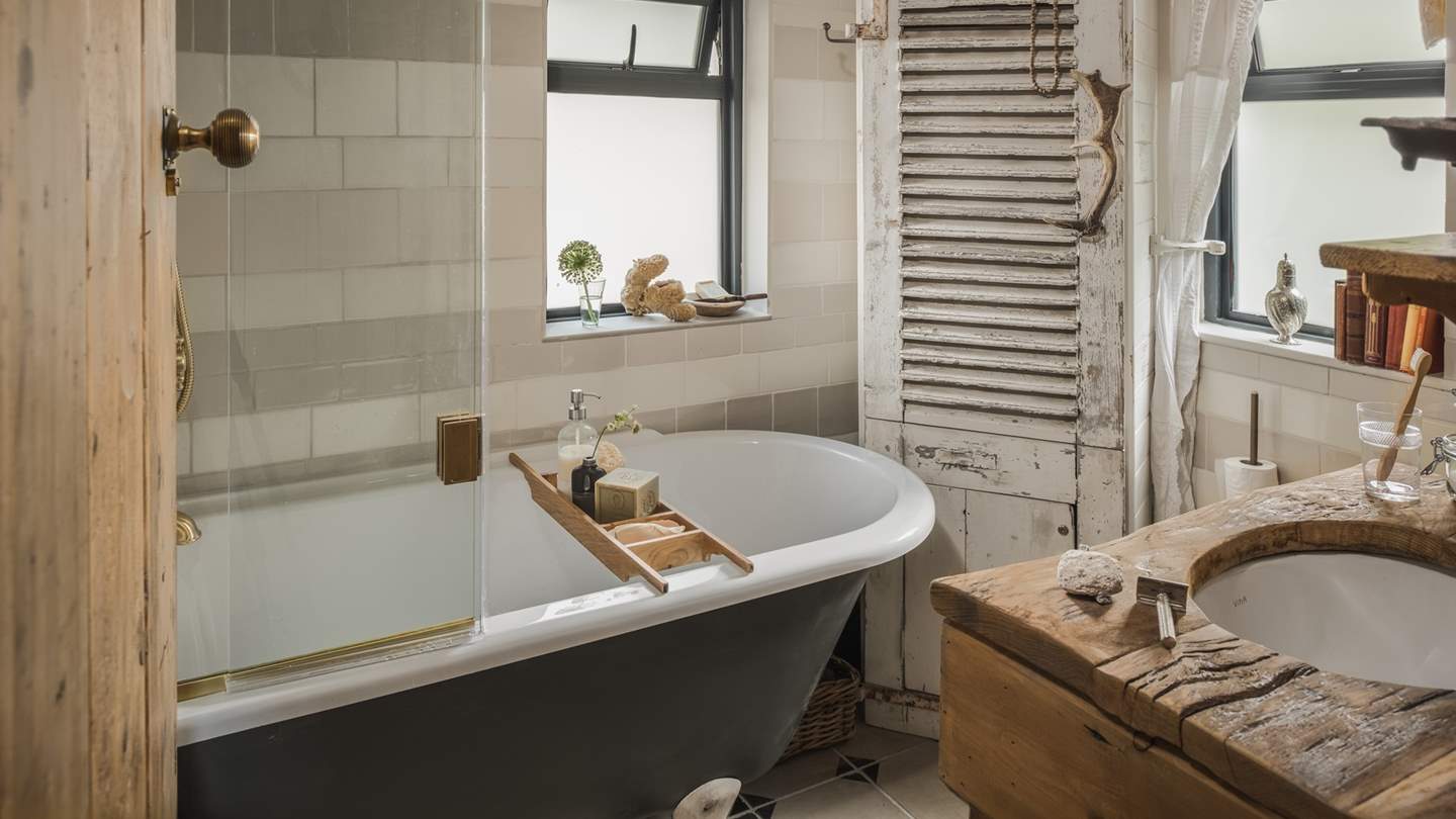 The bathroom, complete with roll top bath with shower overhead - please note, from November 25th 2025, the bath will replaced with a walk-in shower for rejuvenating morning rituals.