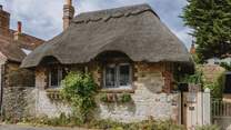 Bedecked in thatch, climbing roses and with golden stone walls and traditional windows, Olea oozes luxury at every turn 