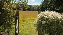 The garden gate leads out into fields, waiting to be explored