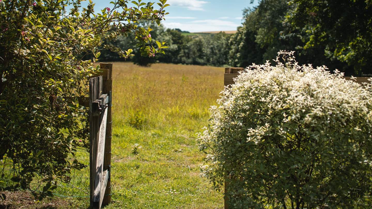 The garden gate leads out into fields, waiting to be explored