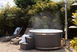 The gorgeous wood-fired hot tub is a dream to admire dusky skies while savouring a glass of something special