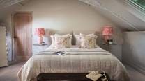 The second bedroom is just divine in cream and pink hues