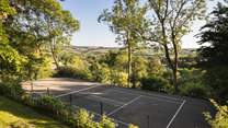 The wonderful tennis court with far-reaching countryside views 