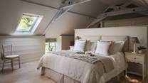 The tranquil room has beautiful vaulted ceilings and a velux window 