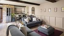 The gorgeous sitting room with beautiful beams and exposed stone walls
