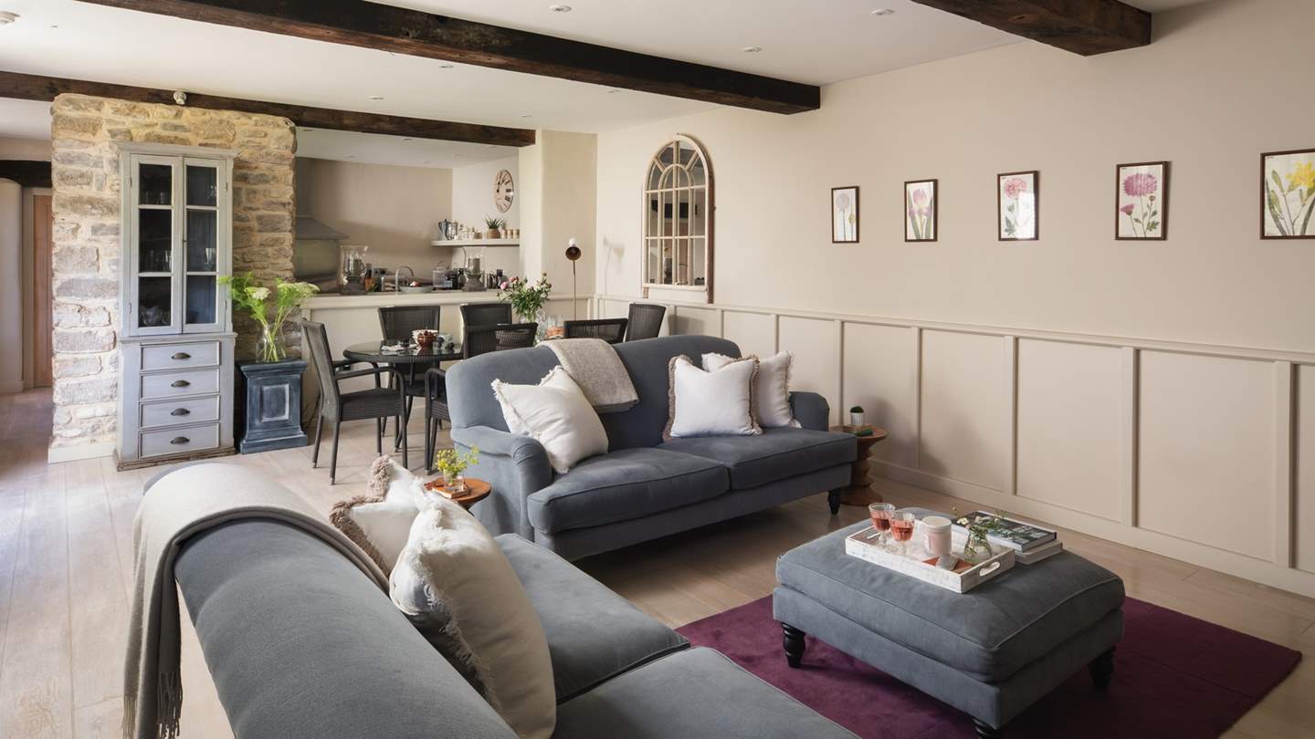 The gorgeous sitting room with beautiful beams and exposed stone walls
